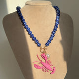Blue Beaded Necklace with Purple Scorpion Pendant